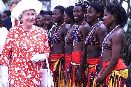 Königin Elizabeth II. besucht im Jahr 1999 Mosambik, das vier Jahre zuvor Mitglied des Commonwealth wurde. Tänzerinnen empfangen die Monarchin.